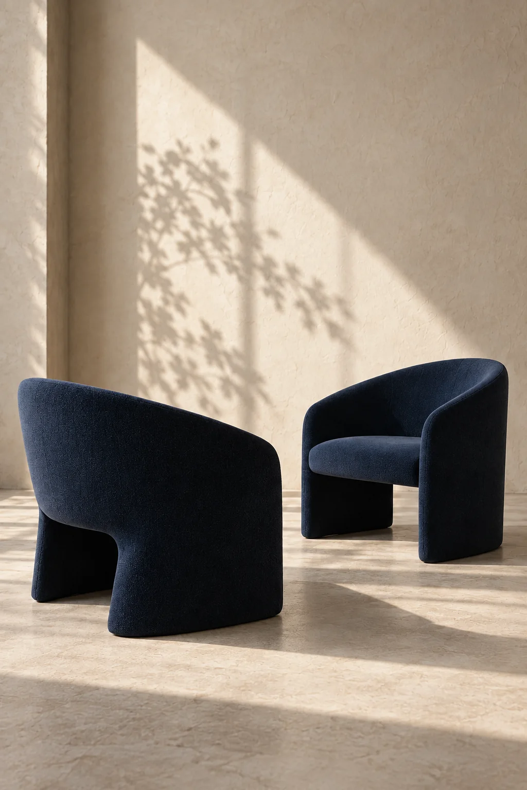 Two navy chairs facing each other in warm sunlight.
